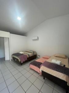 Postel nebo postele na pokoji v ubytování Pousada Sapê