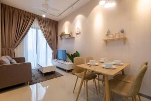 a living room with a table and chairs and a couch at Endless Warming~ 2BR5Pax Southlink Bangsar South in Kuala Lumpur