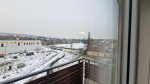 a view of a snowy city from a balcony at Apartament Wieliczka in Wieliczka