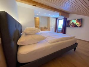 a bedroom with a large bed with two pillows at das Landblick in Sillian