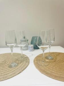 two wine glasses sitting on top of a table at La petite halte in Godshuis