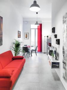 a living room with a red couch and a table at La Casa di Cri in Bologna