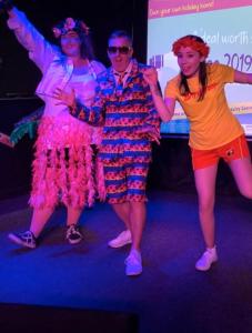 a group of three people dancing on a stage at Lorraine's Caravan Holiday in Morecambe