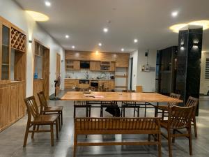 a kitchen with a large wooden table and chairs at Mỡ Villa Cao Bằng in Cao Bằng