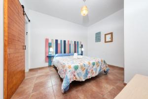 a bedroom with a bed with a table in it at Casa Iria - Private pool and BBQ By Lanzarote Vacation Homes in Playa Blanca +33 photos