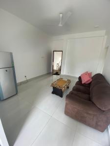 a living room with a couch and a table at Apartment near Colombo Airport in Katunayaka