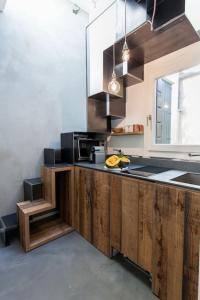 a kitchen with a counter with a sink and a microwave at @HOME - Mini In Centro Storico in Padova