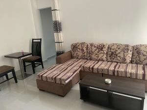 a living room with a couch and a table at Apartment near Colombo Airport in Katunayaka