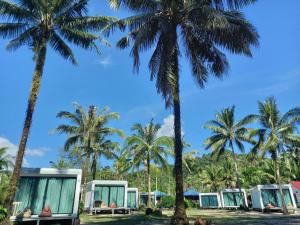 a group of campers under palm trees at Koh Kood Club in Ko Kood