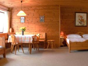 a bedroom with a bed and a table and chairs at Haus Grafhube in Afritz-Verditz in Innere Einöde