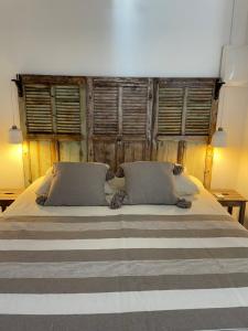 a bedroom with a large bed with two pillows at Ô sparolland in Saint-Mandrier-sur-Mer