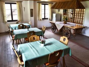 a dining room with green tables and a cart at Holiday home Birkenhof in Afritz Verditz in Verditz