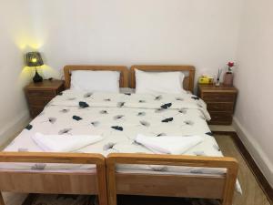 a bedroom with a large bed with white sheets at بيت العُمري (ام قيس) in Um Qeis