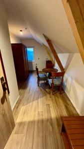 a dining room with a table and chairs in a attic at Wellness Penzion HORSE FARM in Bravantice