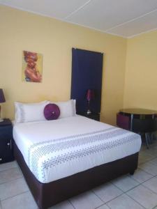 a bedroom with a large bed in a room at Plk Noord Guesthouse in Polokwane