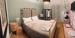 a small bedroom with a bed and a mirror at Cursoli Apartment in Altamura