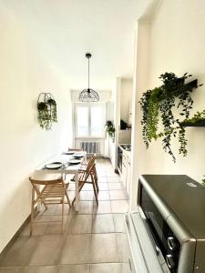 a kitchen and dining room with a table and chairs at Skyscraper 11 in Cinisello Balsamo