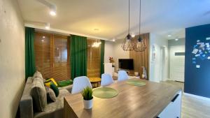 a living room with a couch and a dining table at Apartament Złocień in Krakow