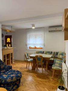 een woonkamer met een tafel en stoelen bij Garden Oasis Apartment in Veles