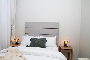 a bedroom with a large white bed with two lamps at Sublime - By LaSerene - Carlswald in Midrand