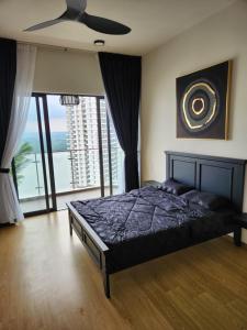 a bedroom with a bed and a ceiling fan at Country Garden Danga Bay in Johor Bahru