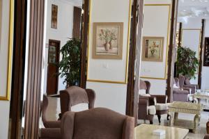 - une salle d'attente avec des chaises et un miroir dans l'établissement Al-faleh Hotel, à Al Baha