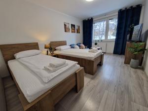 Posteľ alebo postele v izbe v ubytovaní Apartament w Śródmieściu
