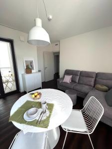 a living room with a table and a couch at Porta 1923 Bed and Art in Gravina in Puglia