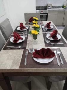 a table with red napkins and plates on it at Exclusive Midori Paradise in Minglanilla
