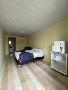 Postel nebo postele na pokoji v ubytování Suite em Penha ao lado do Beto Carrero