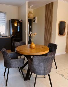 a dining room with a wooden table and chairs at Chatka Niedźwiadka in Uście Gorlickie