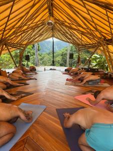 a group of people doing yoga in a tent at Jungle Gayborhood - LGBTQ Boutique Hotel and Retreat in San Luis