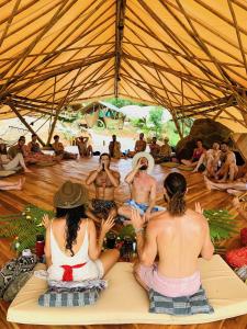 a group of people sitting on the floor in a tent at Jungle Gayborhood - LGBTQ Boutique Hotel and Retreat in San Luis