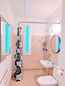 a bathroom with a sink and a shower curtain at Aurora City Apartment in Rovaniemi