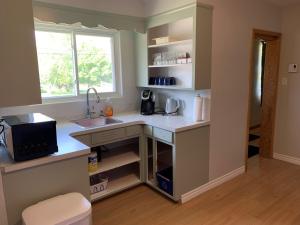 a kitchen with a sink and a window at Lynn's Place in Moncton
