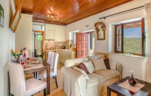a living room and kitchen with a couch and a table at Villa Melissa Paxos in Bogdanátika