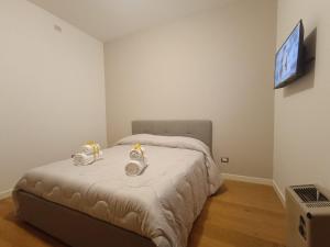 Un dormitorio con una cama con dos relojes de alarma. en Rooms&Suite, en Caserta