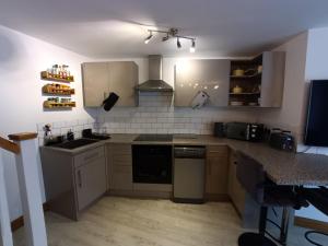 a kitchen with a sink and a counter top at Entire modern cottage close to beach - Pet friendly in Gosport
