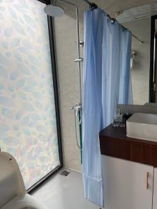 a bathroom with a shower and a sink at Aurora's House in Dồng Văn +19 photos