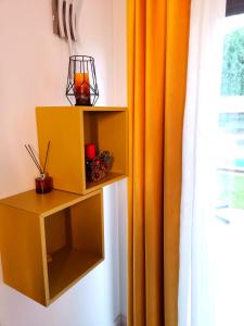 a yellow cabinet next to a window with an orange curtain at VILLA TOMILLARES in Los Tomillares