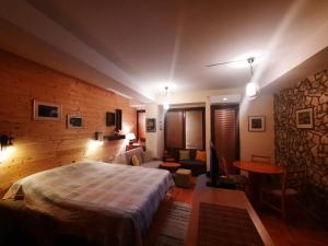 a bedroom with a large bed in a room with a stone wall at Luccia Apartments - Ohrid City Centre in Ohrid