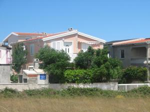 a house with a fence and trees in front of it at Apartment Aria in Vir