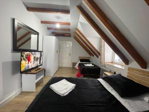 1 dormitorio con 1 cama y TV de pantalla plana en Boga Alpine Resort, en Bogë
