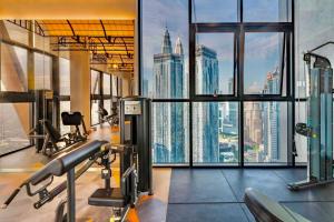 a gym with a view of the empire state building at Scarletz Suites KLCC by M Suites in Kuala Lumpur
