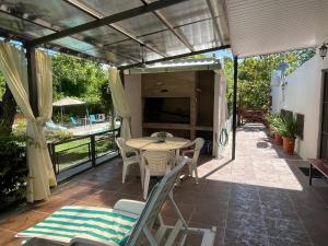 un patio con tavolo e sedie e un balcone. di Magnolio a Colonia del Sacramento