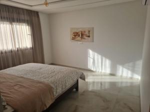 Voodi või voodid majutusasutuse Wilaya Center Suites toas