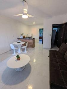 a living room with two tables and a couch at Dpto. a unos pasos de la playa en Las Brisas in Manzanillo