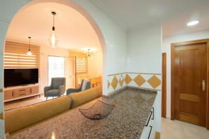 a living room with a couch and a television at Holiday Beach El Olivo in Gran Alacant