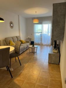 a living room with a couch and a table at MOJACAR WITH POOL, BEACH AND GoLF in Mojácar