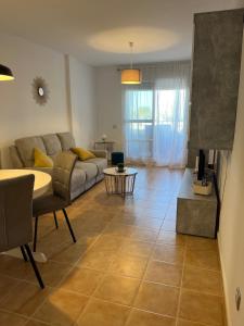 a living room with a couch and a table at MOJACAR WITH POOL, BEACH AND GoLF in Mojácar +7 photos